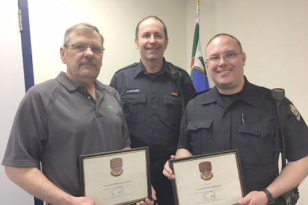 Nelson Police Sergeant Dino Falcone presents Retired Cst. Bill Andreaschuk (left) and Cst. Dan Markevich (right) with the Outstanding Traffic Team honour.