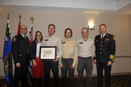 NPD Chief Constable Paul Burkart and Nelson Fire Chief Len MacCharles (far right) present members of Nelson Search and Rescue, Scott Spencer, Brian Cooles and Josh Henschell, with Police Board Certificate of Appreciation for Dedication to Community.