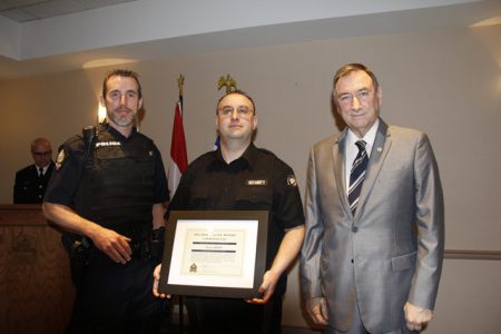 Nelson Police Cst. Chris Duncan and Police Board Director Bill Reid present Steve Rigby with Commendation for Observation and Calm Demeanor.