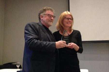 Doug Stoddart of the Community First Health Co-op receiving the Professional Services Excellence Award from Chamber director Karen Bennett.