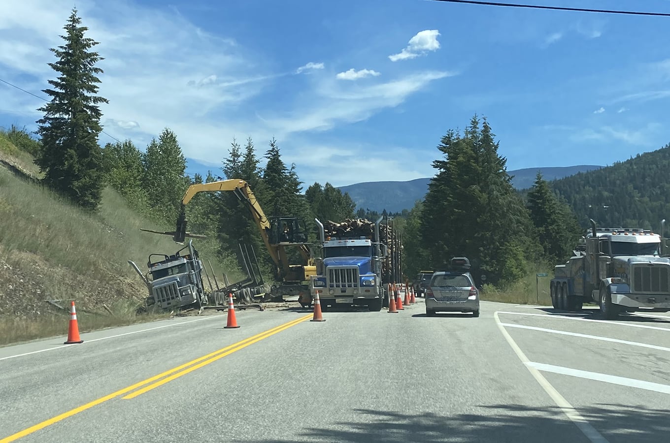 Logging truck slides into ditch west of Nelson
